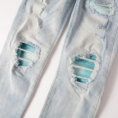 Le style punk est le style masculin déchiré mince taille moyenne bleu denim vintage étirement lavé